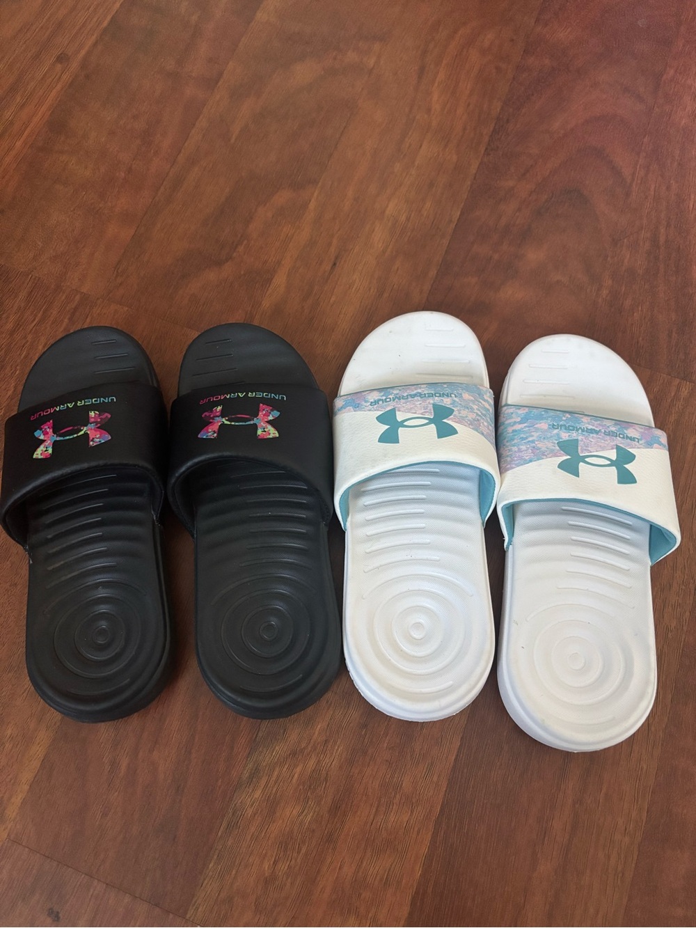 Under Armour Kids' Slide Sandals in Black and White with Floral Logo